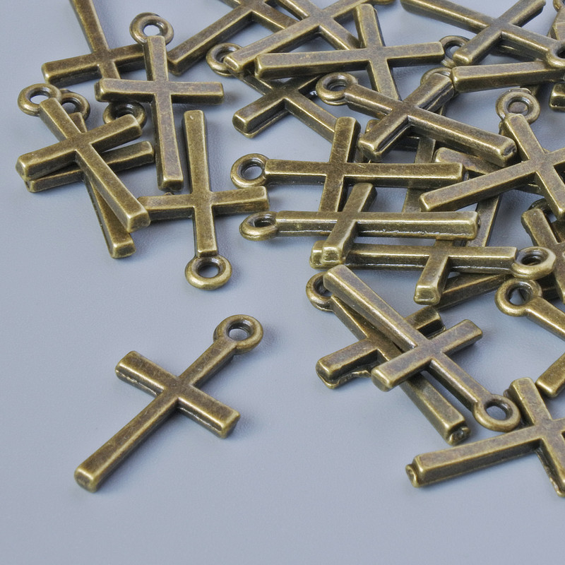 Přívěšek s křížem, bronzová barva kovu, rozměry 18×10 mm, otvor o průměru 1,3 mm, balení 30 ks ±