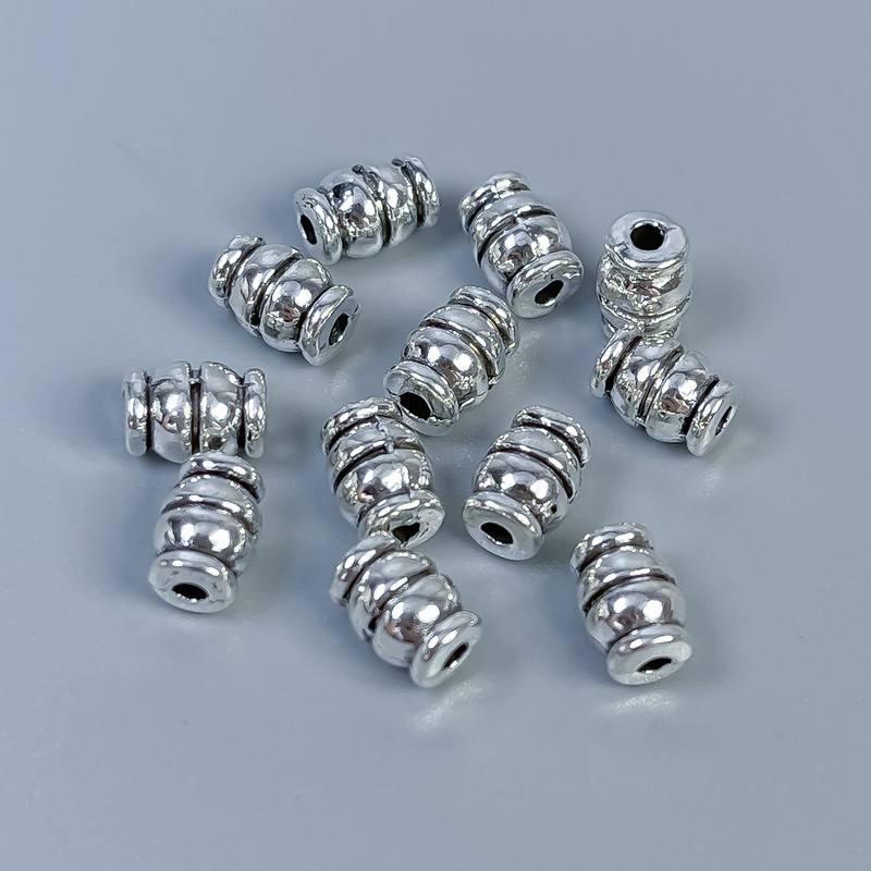 Korálka-vložka – kovová komponenta, barva kovu stříbrná, průměr 7×5 mm ± otvor cca 1,5 mm ± balení 28 ks