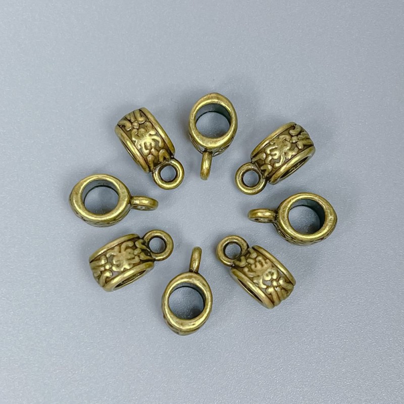 Poutko (bail) bronzové barvy, rozměry 11×6×5 mm ±, otvory 4,5 mm a 2 mm ±, balení 20 ks