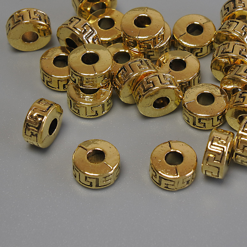 Kovové komponenty – korálka-vložka zlaté barvy, průměr 7×4 mm, otvor cca 2,9 mm, balení 20 g (~25 ks)