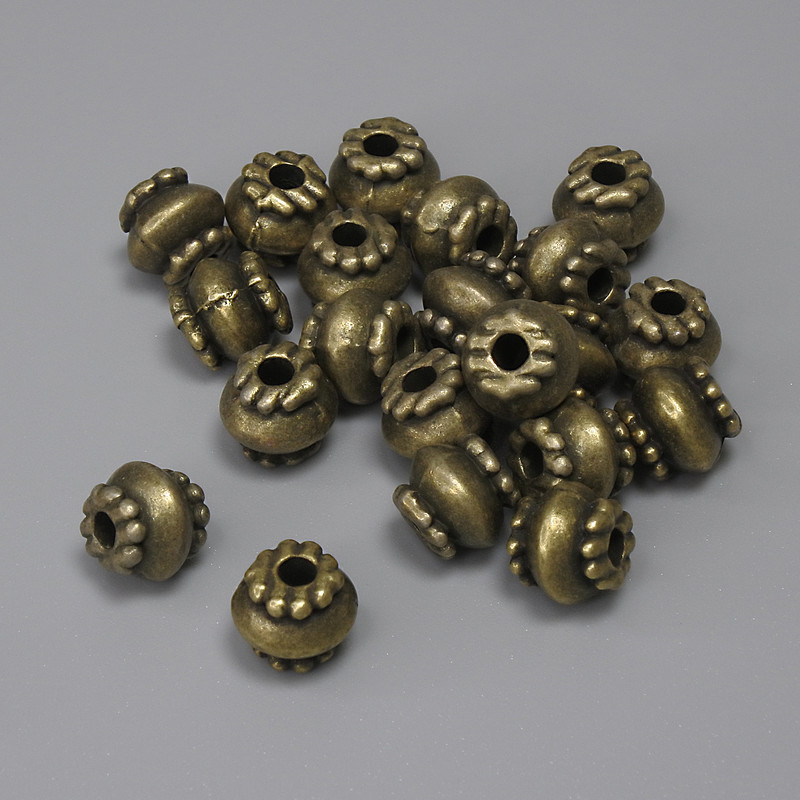 Bronzová korálka-vložka, průměr 6×7 mm, otvor o průměru cca 2,2 mm, balení 22 ks