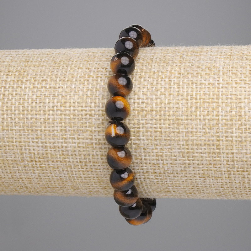 Náramek z tygřího oka, lisovaná hladká kulička, průměr cca 8 mm, délka cca 18 cm, elastický