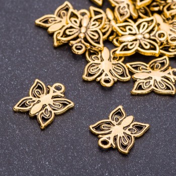 Přívěšek kovový 'Motýlek' ve starozlaté barvě, průměr 13 mm, délka 14 mm, balení 20 g ± 25 ks