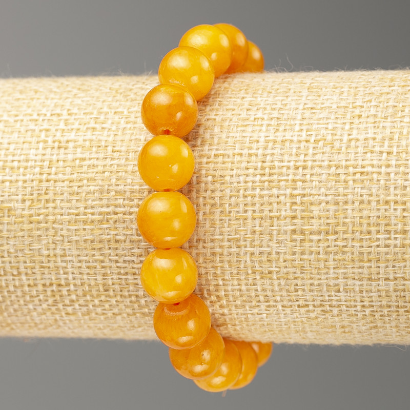 Náramek na gumičce z umělého jantaru (umělý akryl), hladká kulička, průměr 10 mm, délka 18 cm ±
