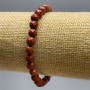 Náramek z červeného jaspisu, fasetované korálky o průměru 6 mm, délka 18 cm (elastický)