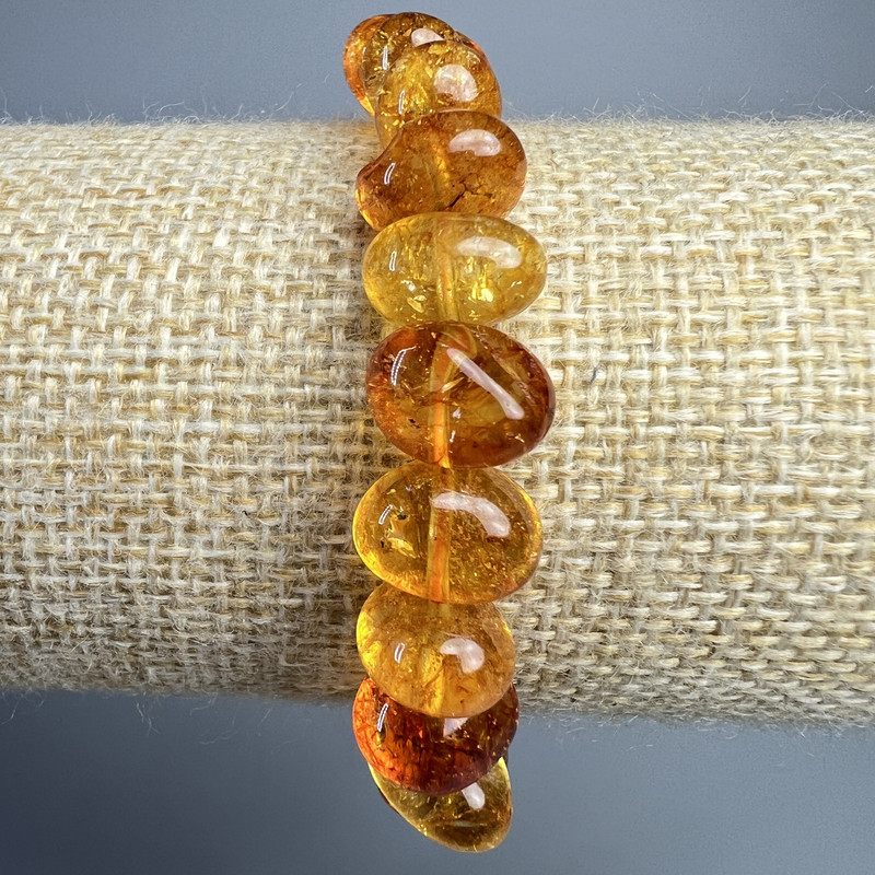 Náramek z křišťálu oranžový, tónovaný do jantarové barvy, facettované korálky, průměr 12×8 mm ±, délka 18 cm ± (na gumičce)