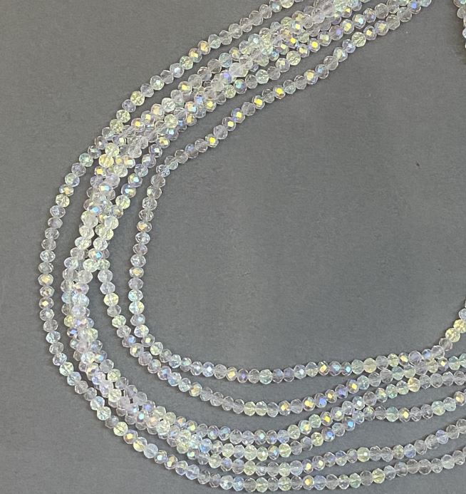 Korálky z českého křišťálu na vlascu bílé průhledné s benzínovým nástřikem, brusované rondely, průměr 3,5×3 mm, délka 33 cm