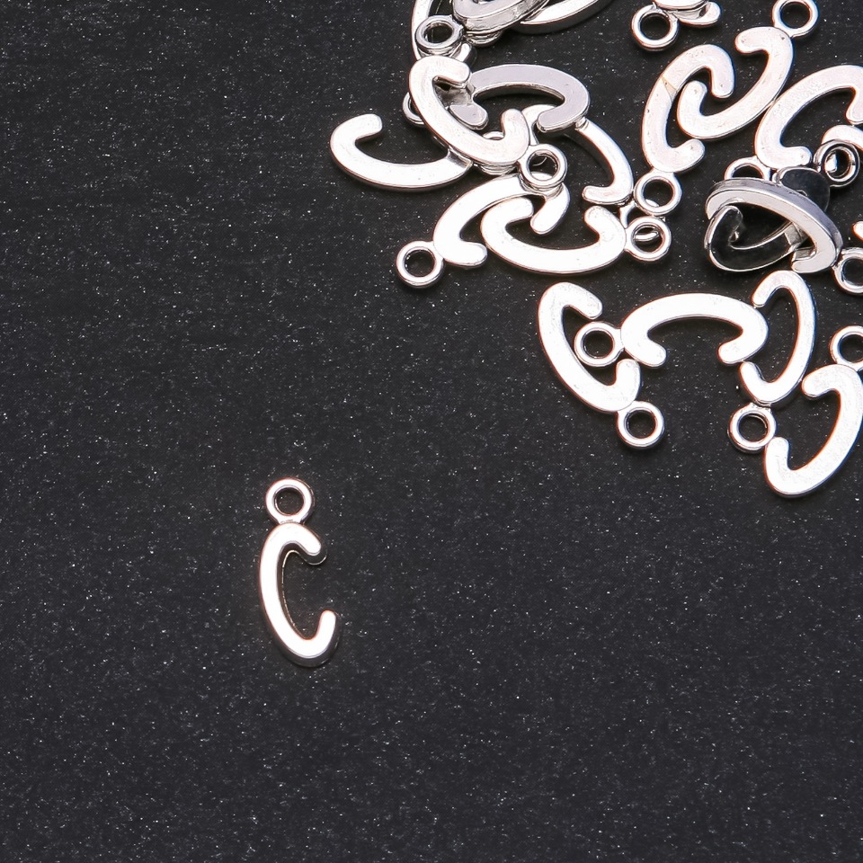 Přívěšek ve tvaru písmene C, 17×7 mm, balení 20 g (± 30 ks)