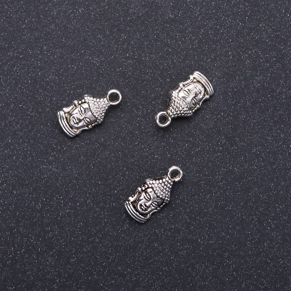 Přívěsek Buddha, průměr 7 mm, délka 16 mm, průměr 1,8 mm, balení 20 g, 15 ks (+ -)