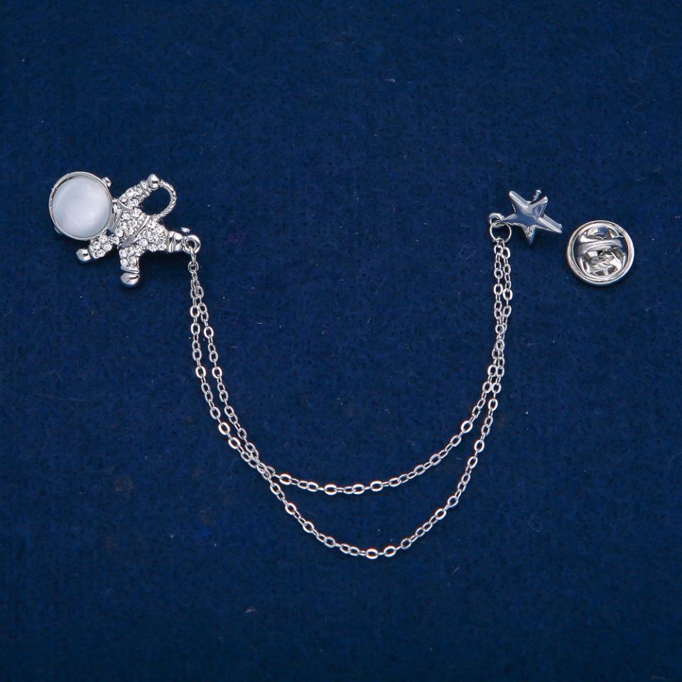 Brož kosmonaut s cabochonem kočičí oko a bílými štrasovými kamínky, stříbrný kov 27×20 mm + -, délka 12 cm +