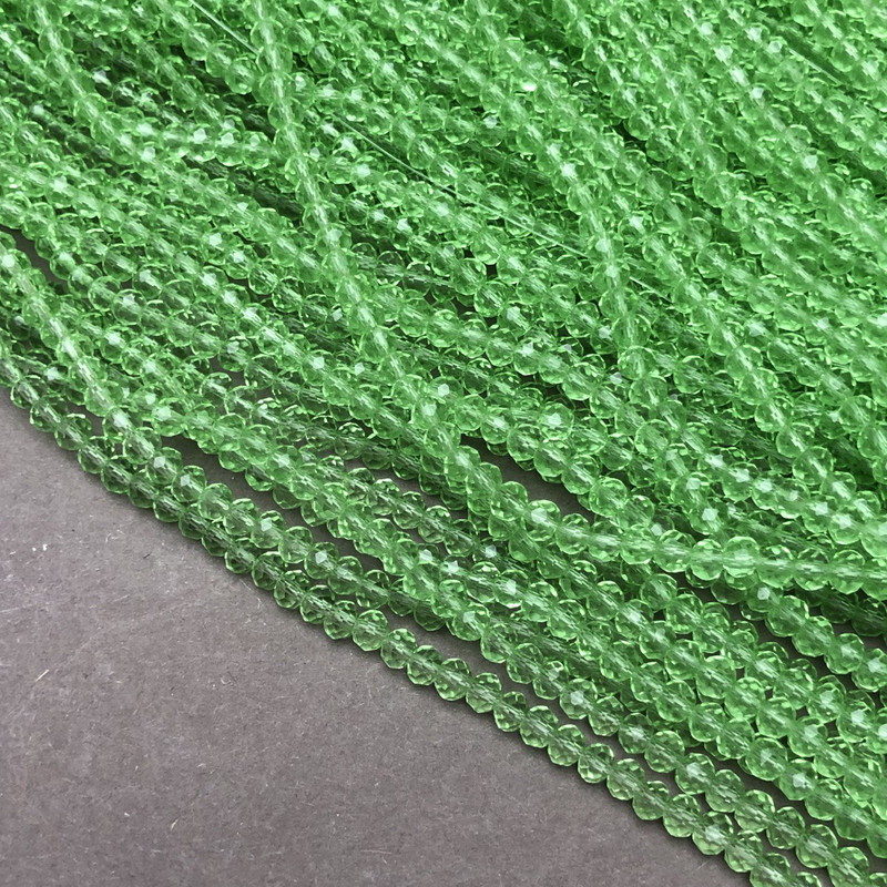 Korálky Český křišťál na niti, salátově zelené, průhledné, broušené rondely, průměr 3,5×3 mm, délka 36–38 cm