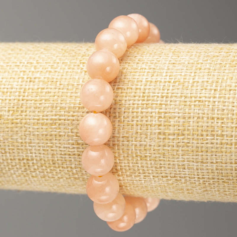 Náramek na gumičce ze syntetického akrylu napodobující jemný selenit, hladká kulička, průměr 10 mm ±, délka 18 cm ±